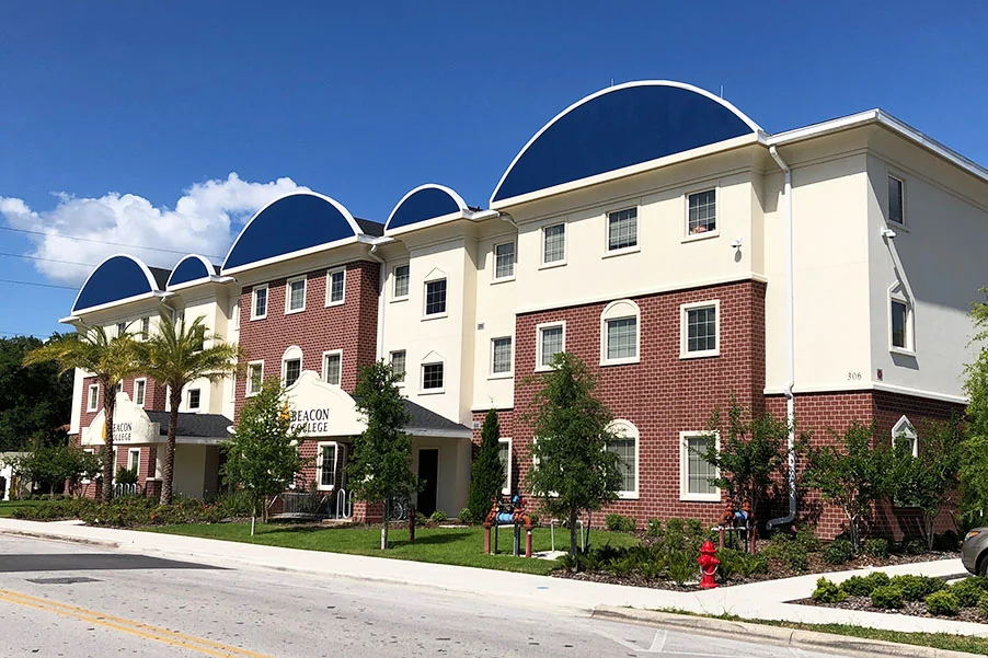 Beacon College residence hall with red and cream facades and curved roof details